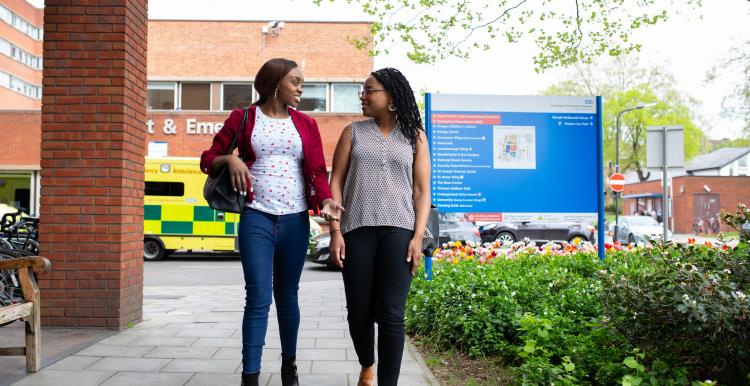 women walking in front of ambulance