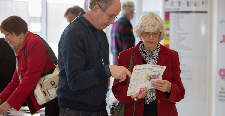 Man and woman talking about leaflet