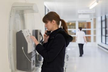 Woman at payphone