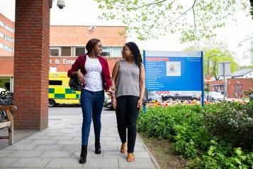 women walking in front of ambulance 