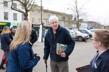 Man with walking stick talking to Healthwatch