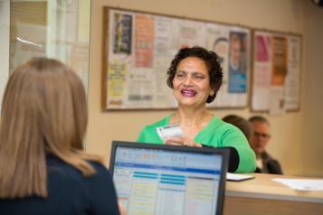 Woman talking to receptionist